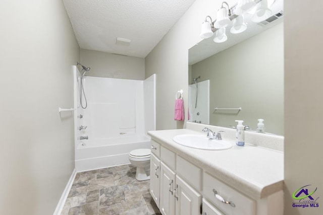 full bathroom featuring vanity, a textured ceiling, shower / bathtub combination, and toilet