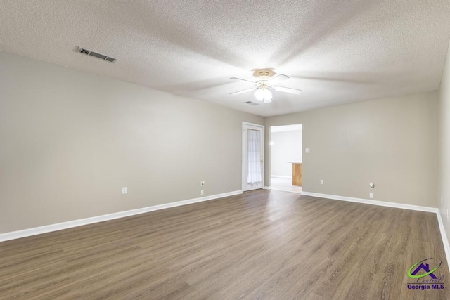 unfurnished room with hardwood / wood-style floors, a textured ceiling, and ceiling fan