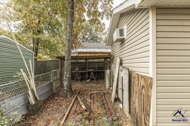 view of yard with a wall mounted air conditioner