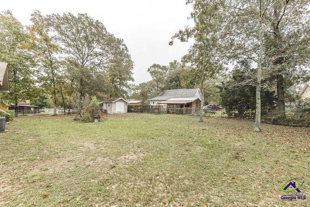 view of yard with a shed and central AC unit