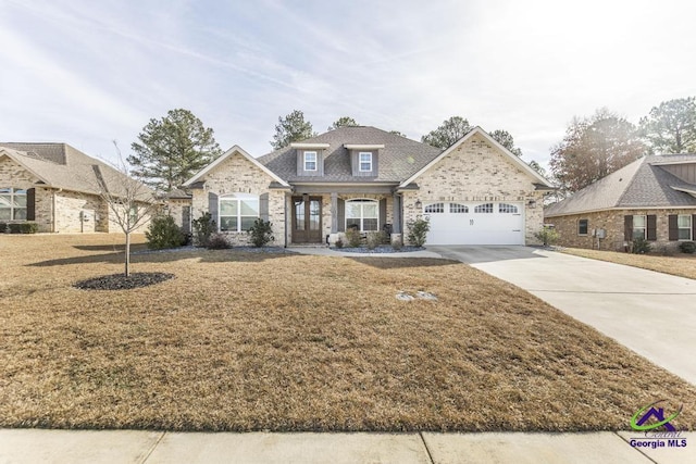 view of front of house featuring a garage and a front lawn