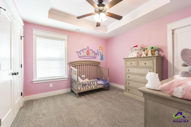 bedroom featuring light carpet, ornamental molding, a raised ceiling, and ceiling fan