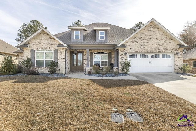 view of front of house featuring a garage, a front yard, and french doors