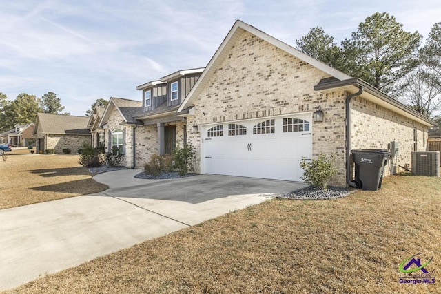 view of front of home featuring a garage, a front yard, and central air condition unit