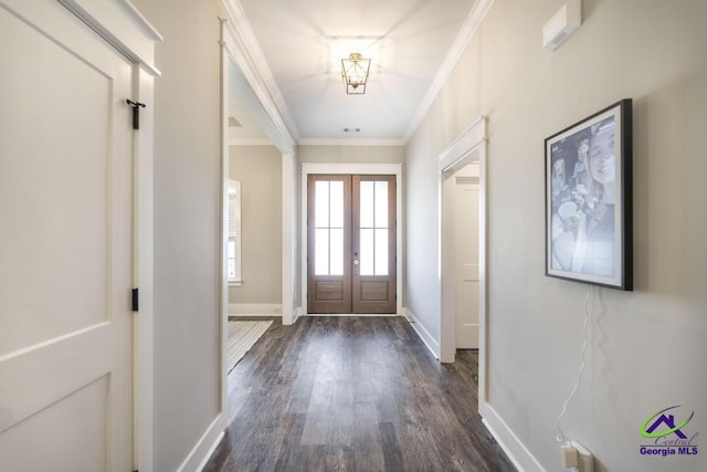 doorway featuring crown molding, dark wood-type flooring, and french doors