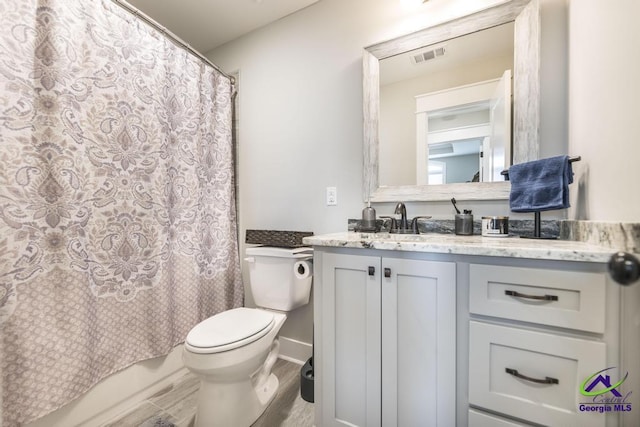 bathroom with hardwood / wood-style flooring, vanity, and toilet