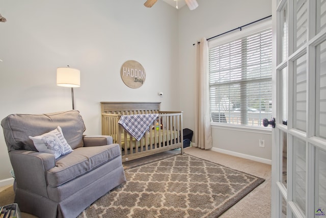 carpeted bedroom with ceiling fan and multiple windows