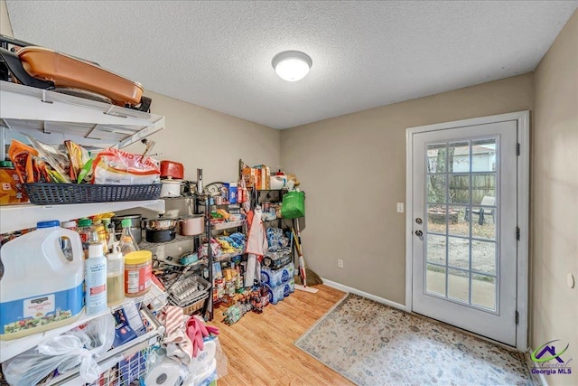 doorway featuring hardwood / wood-style flooring and a textured ceiling