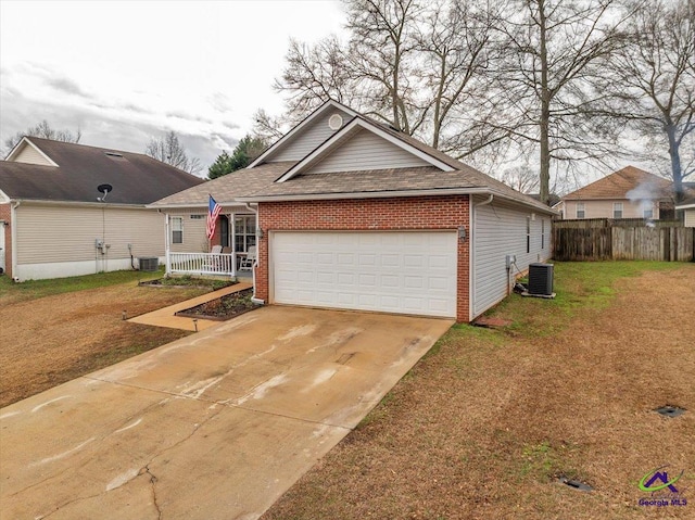 view of front of house featuring a garage, a porch, central AC, and a front yard