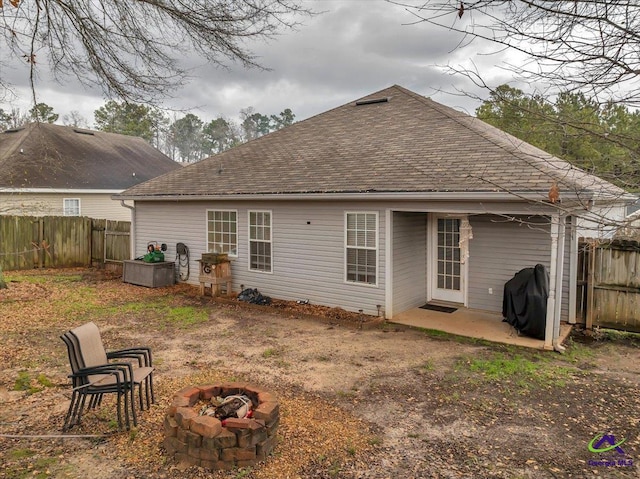 back of house with a patio and an outdoor fire pit