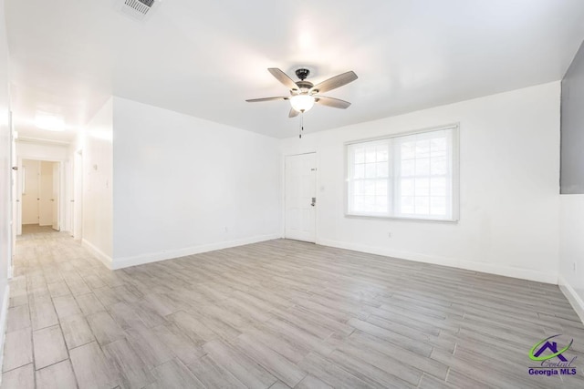 spare room featuring light hardwood / wood-style floors and ceiling fan