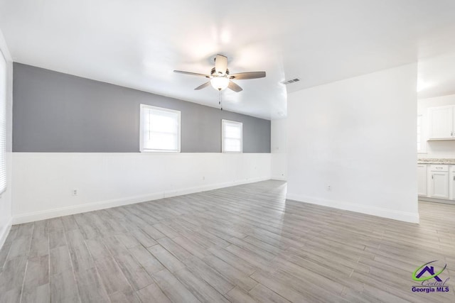 empty room featuring ceiling fan and light wood-type flooring