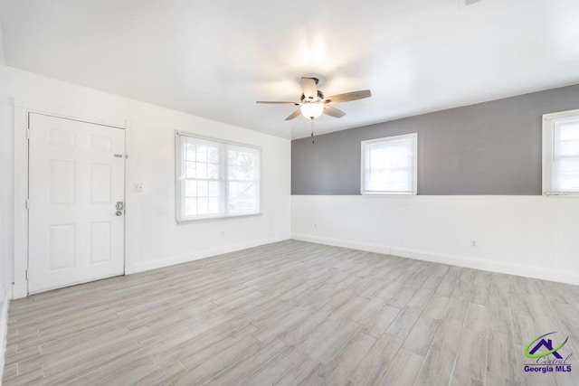 unfurnished room featuring light wood-type flooring and ceiling fan