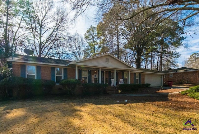 ranch-style house with a garage, covered porch, and a front lawn