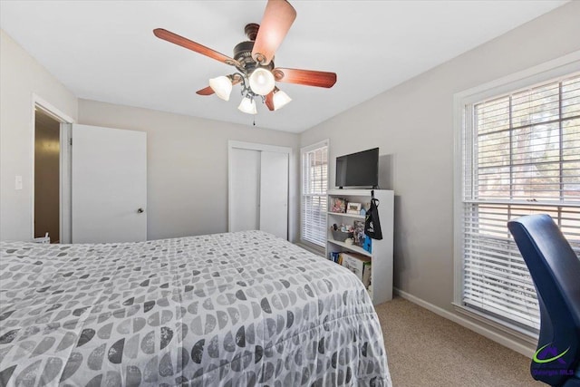 carpeted bedroom with a closet and ceiling fan