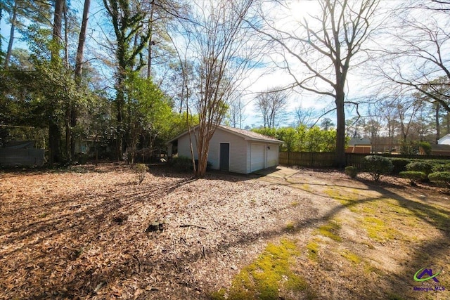 exterior space with a garage and an outbuilding