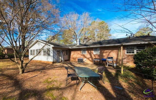 rear view of property featuring cooling unit and a patio area