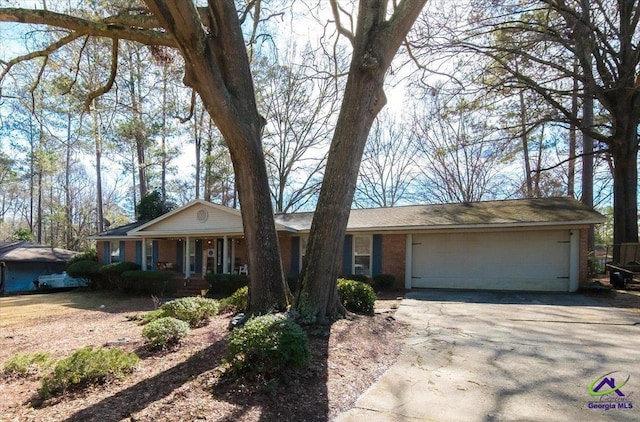 ranch-style house with a garage and a porch