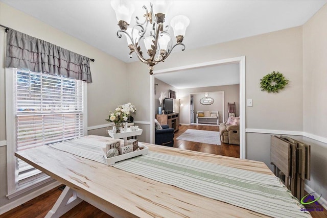 dining space featuring dark wood-type flooring, radiator heating unit, and a chandelier