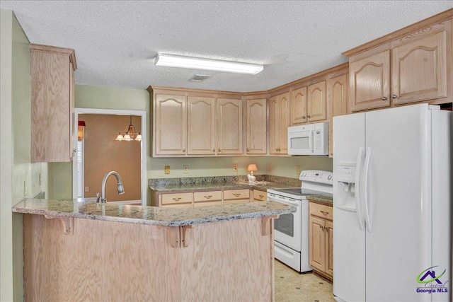 kitchen with a kitchen breakfast bar, light brown cabinetry, white appliances, and kitchen peninsula