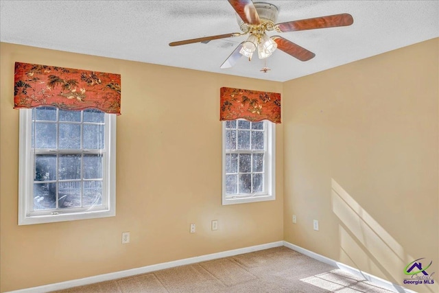 carpeted spare room with ceiling fan and a textured ceiling