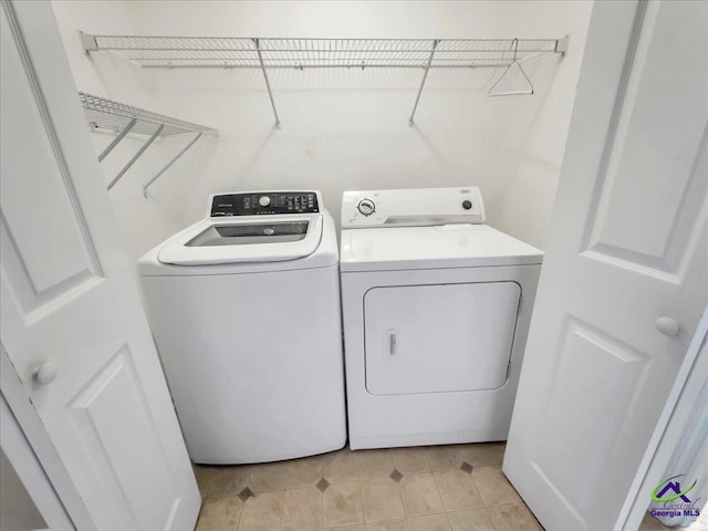 clothes washing area featuring washer and clothes dryer