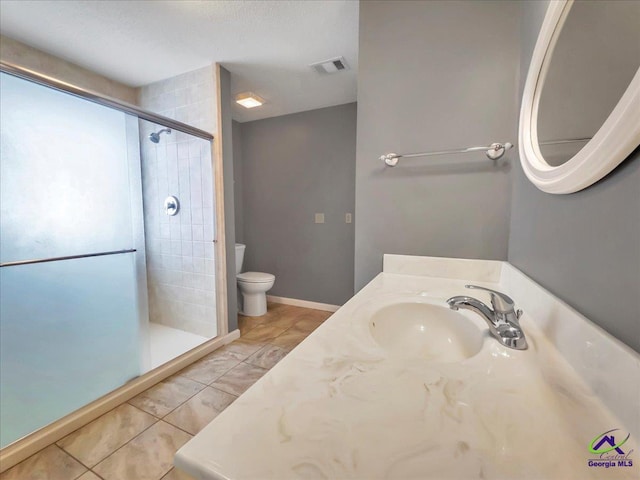 bathroom featuring an enclosed shower, vanity, and toilet