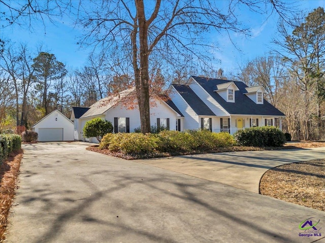 cape cod-style house featuring a garage