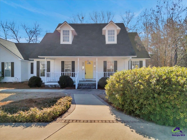 cape cod-style house featuring a porch