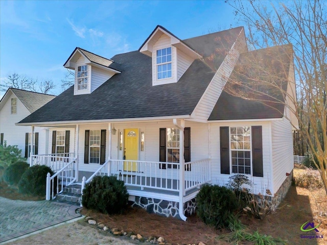 cape cod-style house featuring covered porch