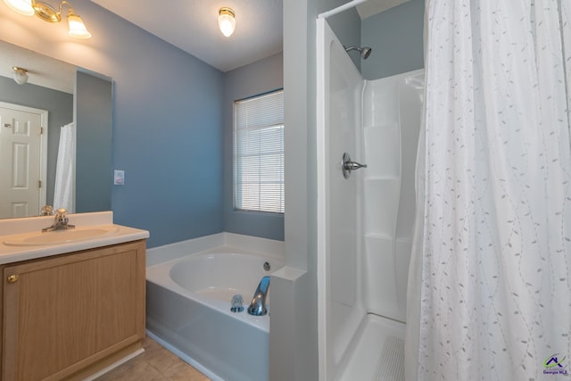 bathroom featuring independent shower and bath, vanity, and tile patterned floors