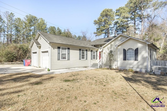 single story home with a garage and a front lawn