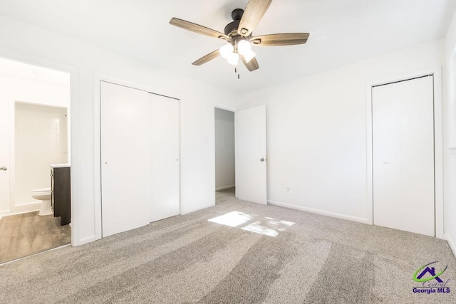 unfurnished bedroom featuring connected bathroom, ceiling fan, and carpet