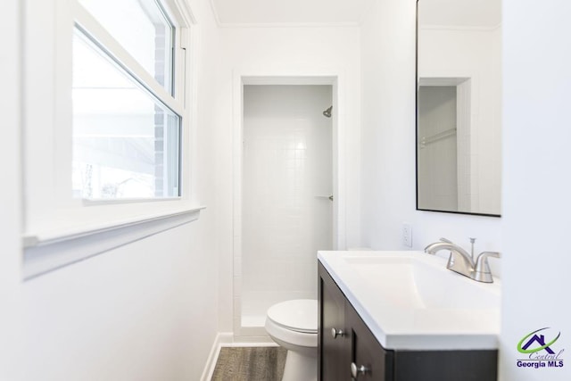 bathroom with toilet, a shower, crown molding, wood-type flooring, and vanity