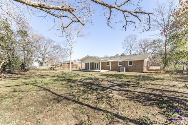 rear view of house featuring a yard and a patio area