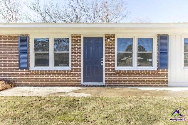 property entrance with a yard