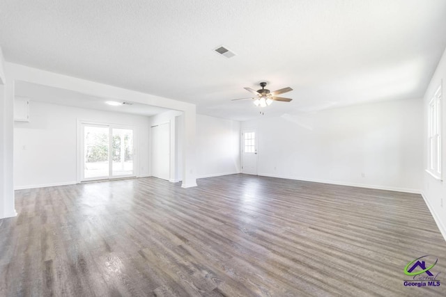 empty room with dark hardwood / wood-style floors and ceiling fan