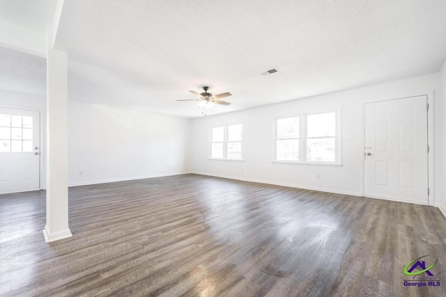 unfurnished living room with ceiling fan and dark hardwood / wood-style flooring