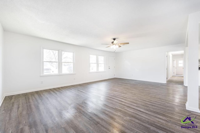 spare room with ceiling fan and dark hardwood / wood-style flooring