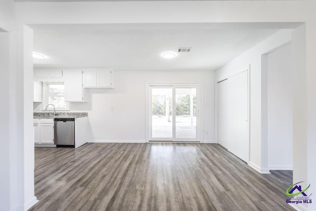 kitchen featuring dishwasher, wood-type flooring, sink, and white cabinets