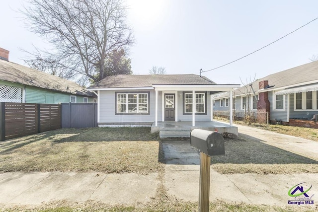 ranch-style house featuring a front yard and covered porch