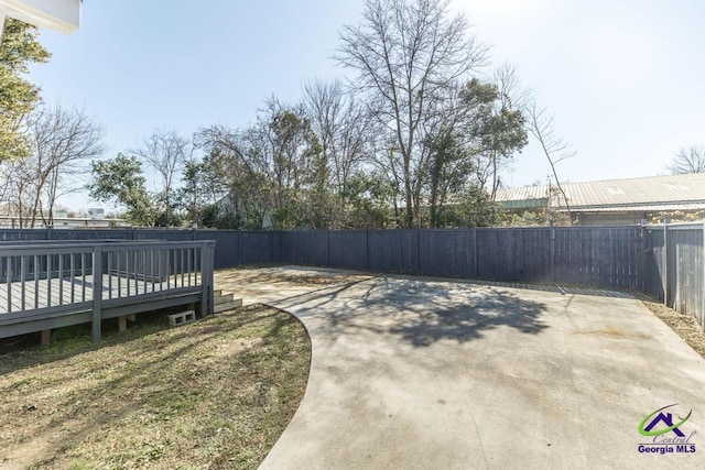 view of yard featuring a deck and a patio