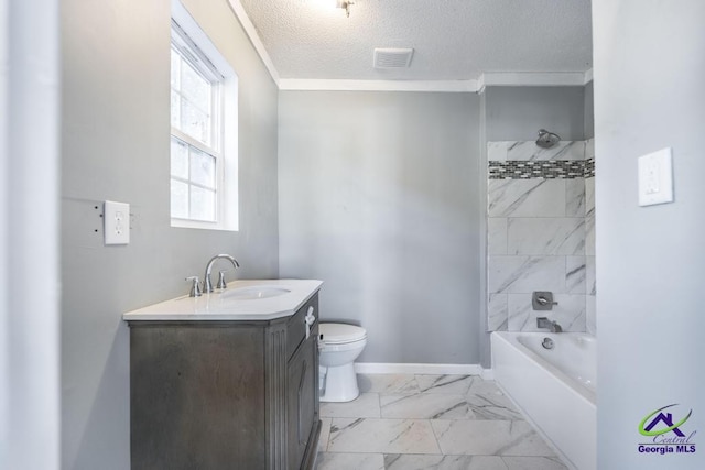 full bathroom featuring crown molding, tiled shower / bath combo, vanity, a textured ceiling, and toilet