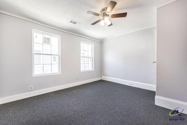 carpeted spare room with ceiling fan and a textured ceiling