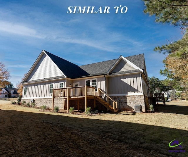 rear view of property featuring cooling unit, a deck, and a lawn