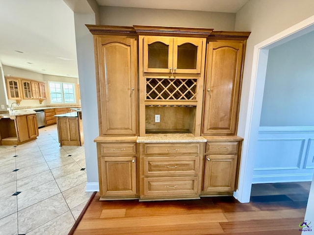 bar with dishwasher and light stone countertops