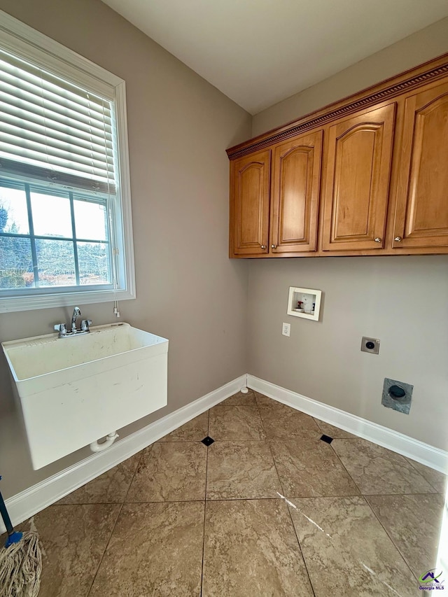 laundry area with electric dryer hookup, hookup for a washing machine, and cabinets