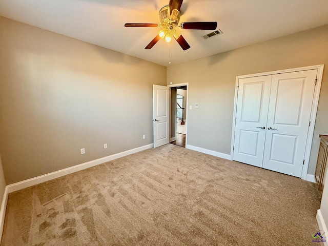 unfurnished bedroom with carpet, ceiling fan, and a closet