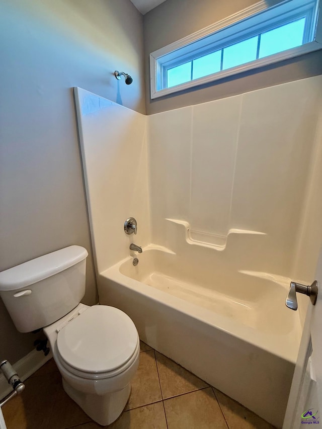 bathroom featuring tile patterned floors, toilet, and shower / bathing tub combination