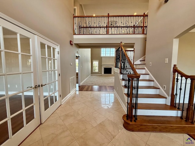 entrance foyer with a high ceiling and french doors